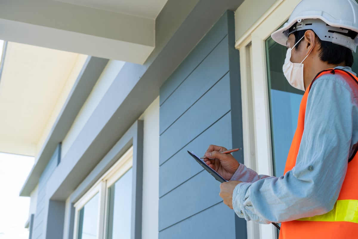 Man Inspecting a House